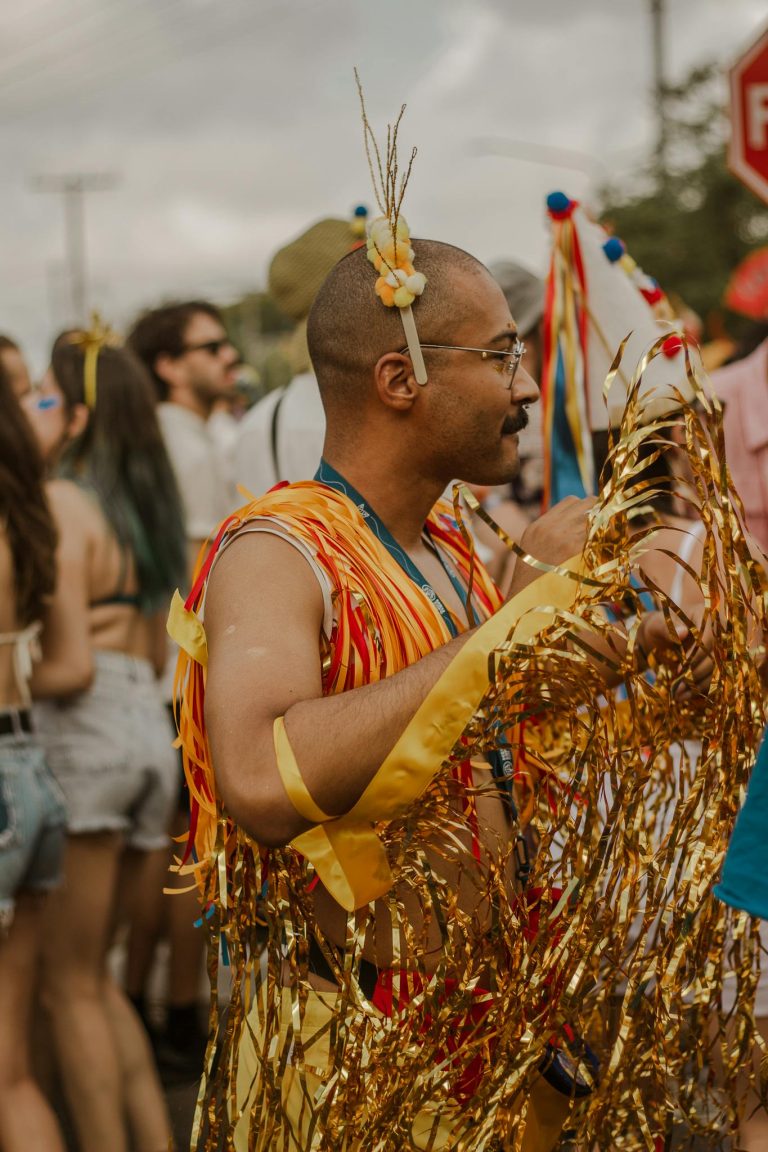A vibrant outdoor celebration featuring people in colorful costumes and festive decorations.