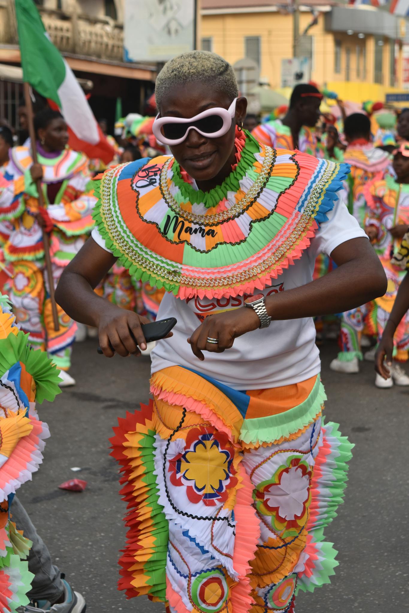 Participants in vibrant, colorful costumes at a lively carnival parade.